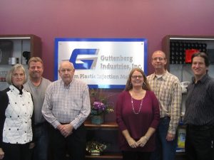 Enjoying their new office space, located in Garnavillo, Iowa are Guttenberg Industries, Inc., founders Pat and John Ertl, left, with son Jim Ertl (back), daughter Deb Moser, son Tom Ertl, and president David Kreul. (Press photo by Molly Moser)